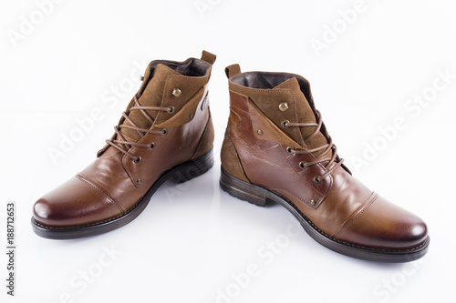 Male brown leather boot on white background, isolated product, comfortable footwear. © GeorgeVieiraSilva