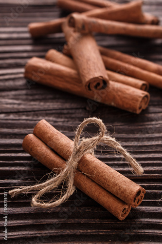 Cinnamon essential oil on a wooden background