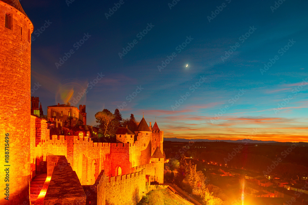 Carcassonne medieval fortress highlighted night view with moon in blue sky