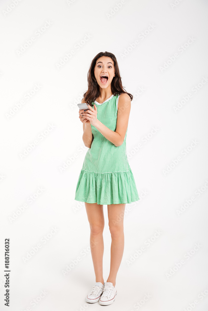 Full length portrait of a surprised girl in dress