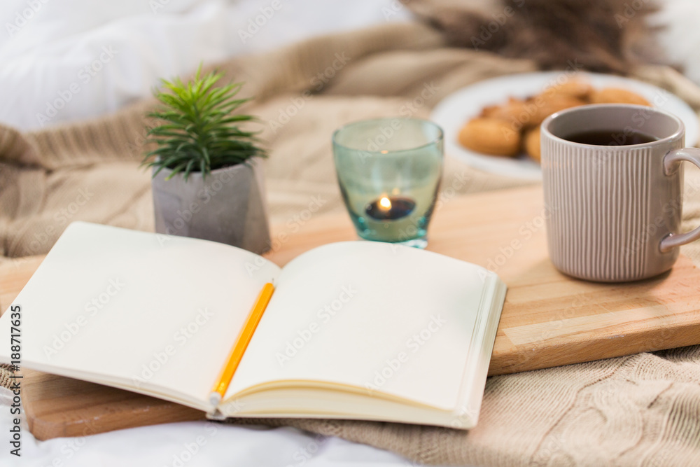diary, tea and candle in holder at home diary, tea and candle in holder at home