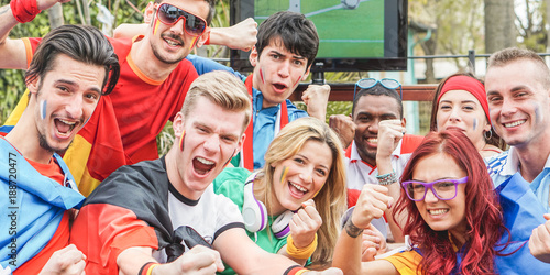 Happy sport fans having fun during football world game © DisobeyArt