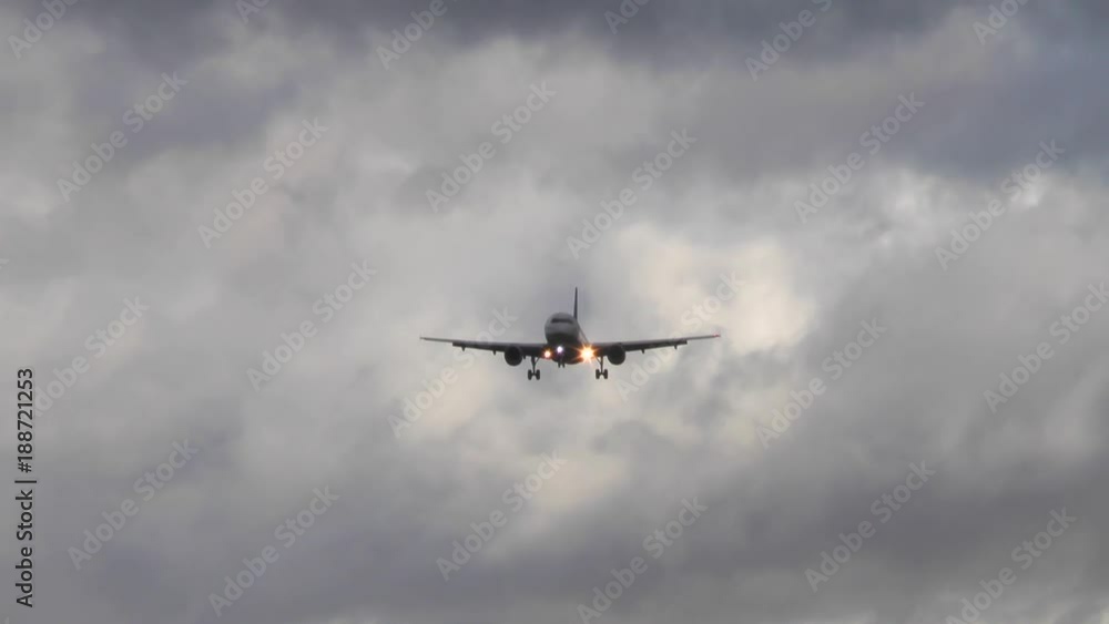 An airplane approaches runway Northwest of Airport Frankfurt, Germany during strong winds - low-angle view An airplane approaches runway Northwest of Airport Frankfurt, Germany during strong winds - low-angle view