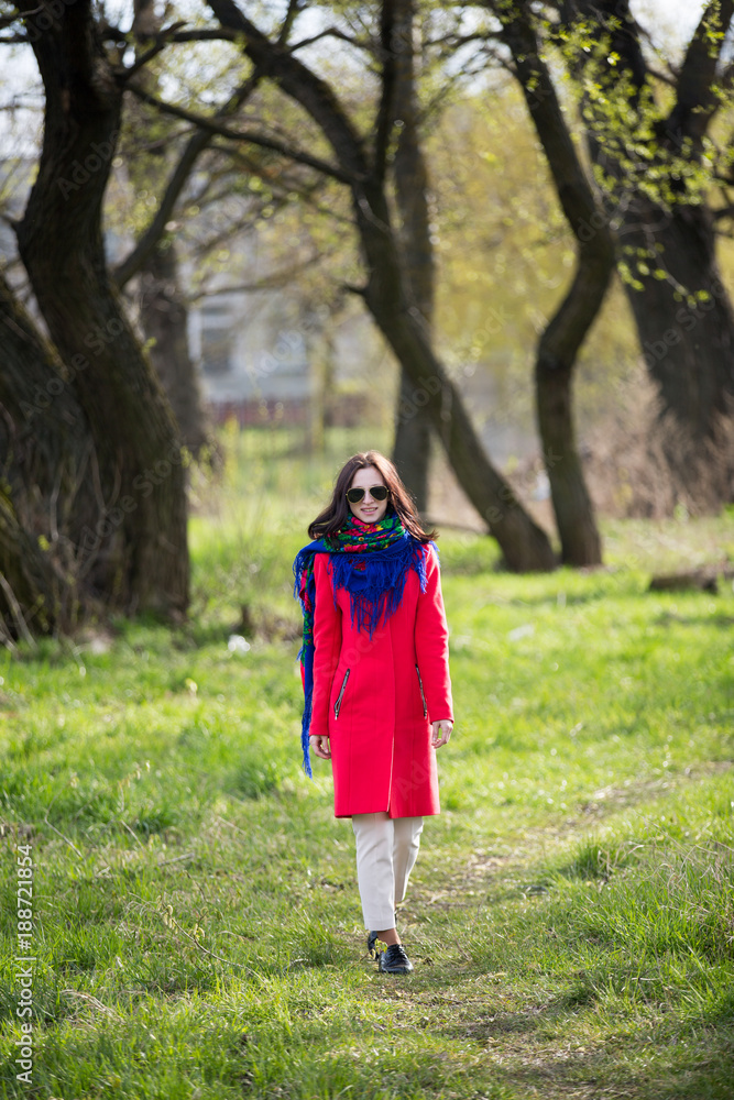 Young lady in coat and sunglasses Young lady in coat and sunglasses