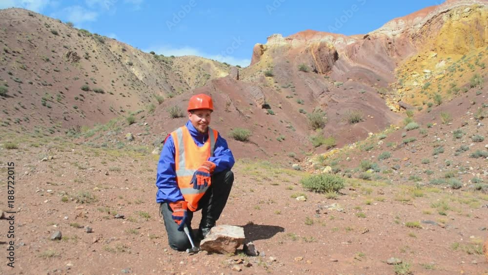geologist tap a rock formation with a hammer geologist tap a rock formation with a hammer