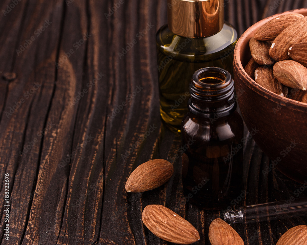 almond essential oil on a wooden background almond essential oil on a wooden background