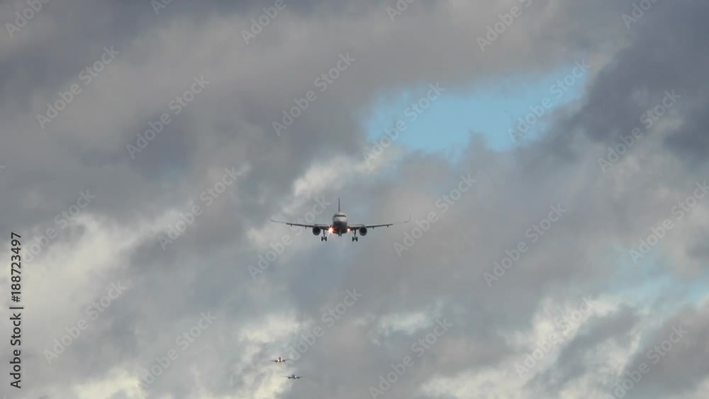 An airplane approaches runway Northwest of Airport Frankfurt, Germany during strong winds - low-angle view An airplane approaches runway Northwest of Airport Frankfurt, Germany during strong winds - low-angle view