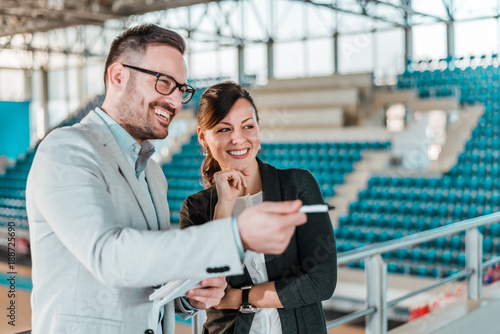 Fototapeta Naklejka Na Ścianę i Meble -  Meeting in a sport hall. Business men and woman in a sport stadium.