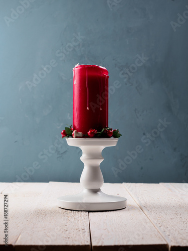 Christmas candle with stand on the wood board