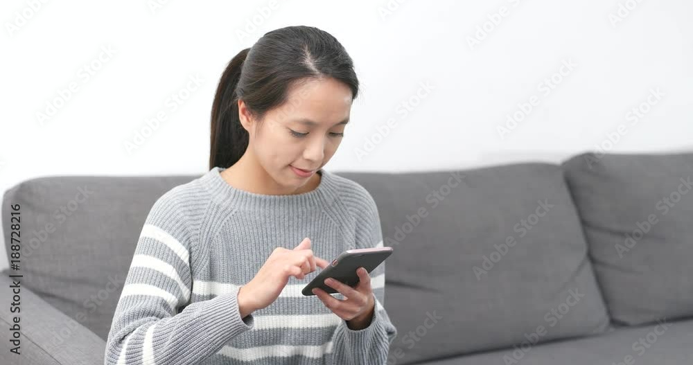 Woman using mobile phone at home Woman using mobile phone at home