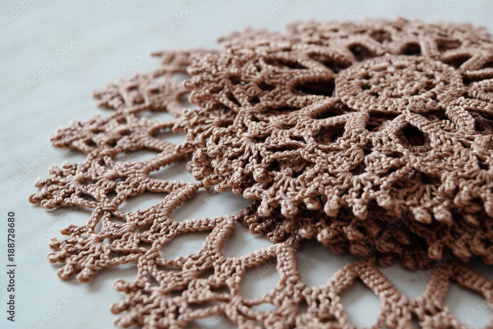 Obraz premium Brown hand hooked coaster. Knitted holders for hot work.