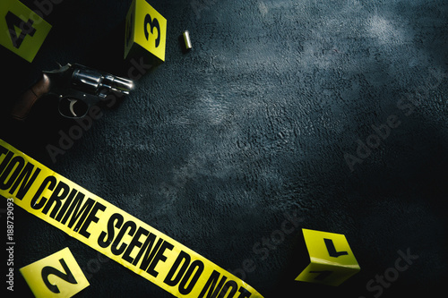 Fotografija Crime scene concept with a gun and evidence markers , high contrast image