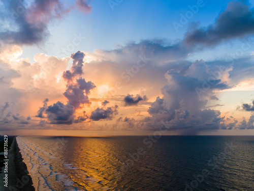 An aerial stormy beach sunrise with beautiful colors. photo