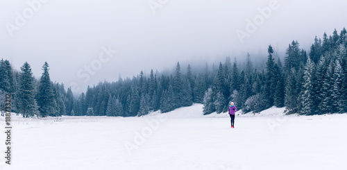 Woman running on winter trail, fitness inspiration and motivation
