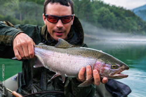 Fisherman with catch of Rainbow trout, Slovenia