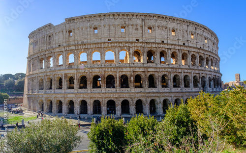 Colosseum Rome. Ruins of the ancient Roman amphitheatre. Travel to Italy, Europe. Crowd and queue. Sunny day and blue sky