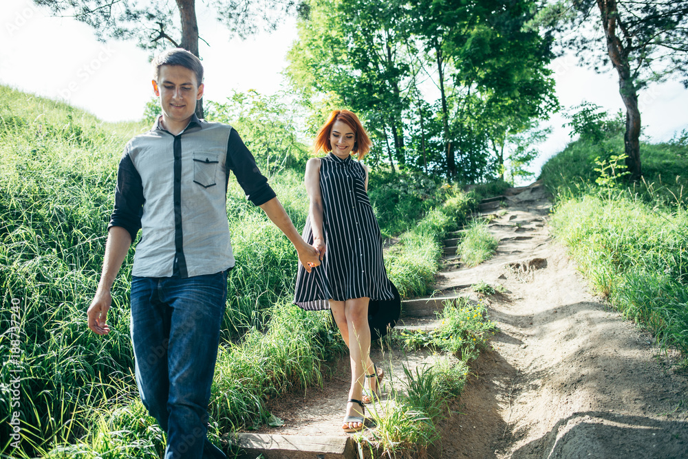 lovely couple climbing up by the hill lovely couple climbing up by the hill