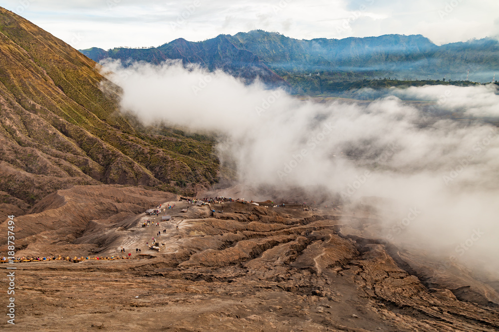 Aerial view from Bromo volcano on the Tengger caldera. Below you can see cones of Batok mount as well as the Hindu monastery. Bromo Tengger Semeru National Park, East Java, Indonesia