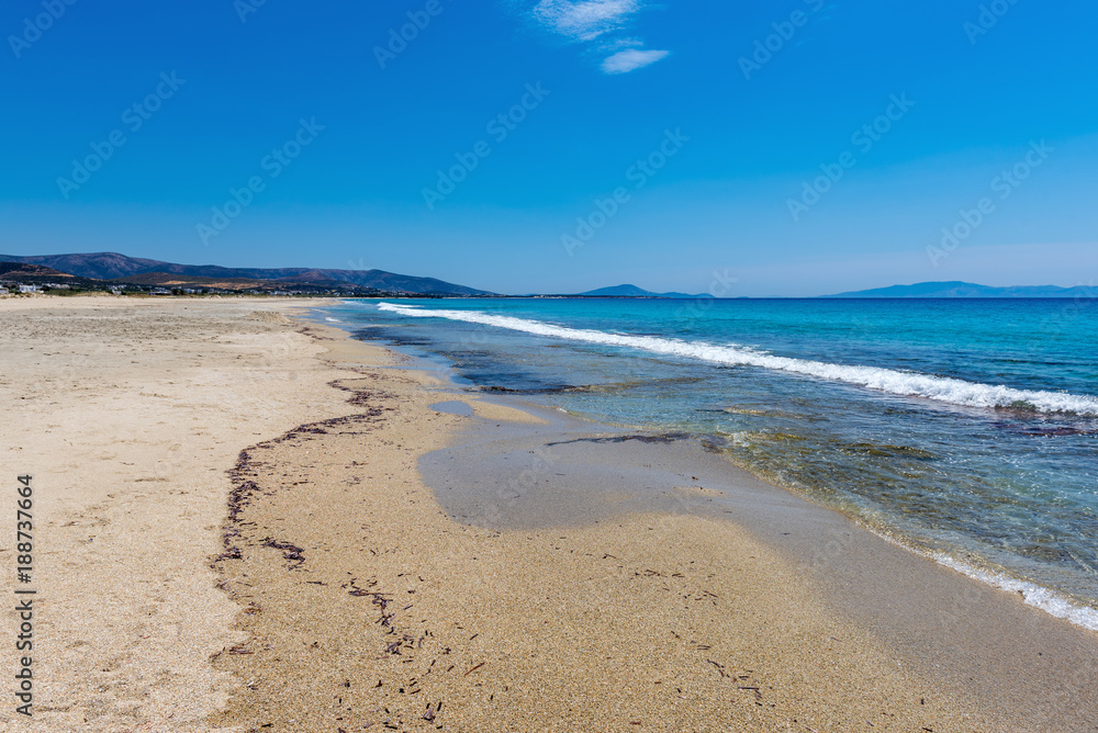 Sandy beach with shallow crystal clear sea water in Mikri Vigla, Naxos island. Greece