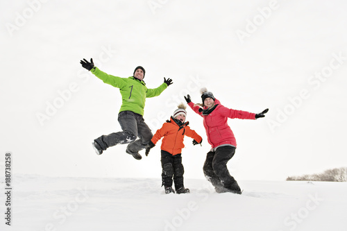family and child spending time outdoor in winter