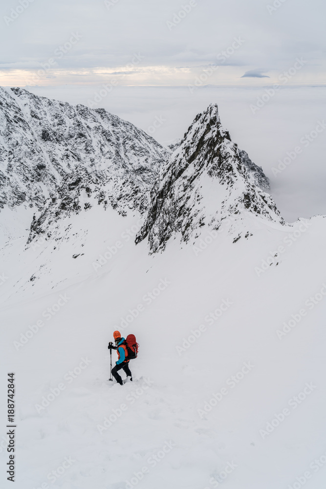 Men hiking in high snowy mountains in winter