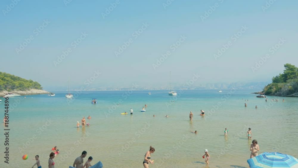Beach with turquoise sea water and golden yellow sand. Blue sky. Summer at Adriatic sea, Lovrecina beach on island Brac, Croatia. Beach with turquoise sea water and golden yellow sand. Blue sky. Summer at Adriatic sea, Lovrecina beach on island Brac, Croatia.