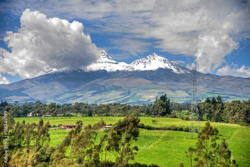Beautiful view of the snow caped Illinizas volcano, in the Ecuadorian Andes, on a sunny and overcast morning.