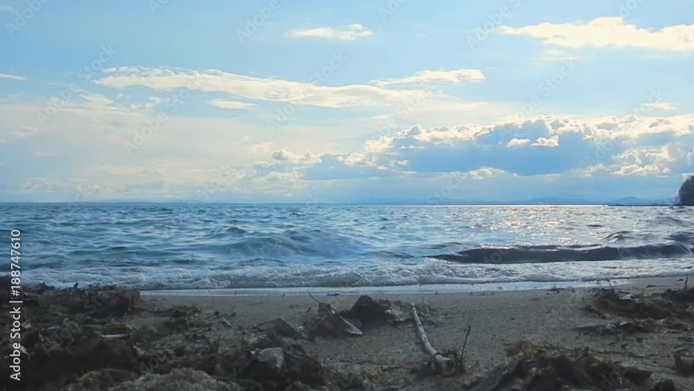 Calm waves on lake in the light of sunset Calm waves on lake in the light of sunset