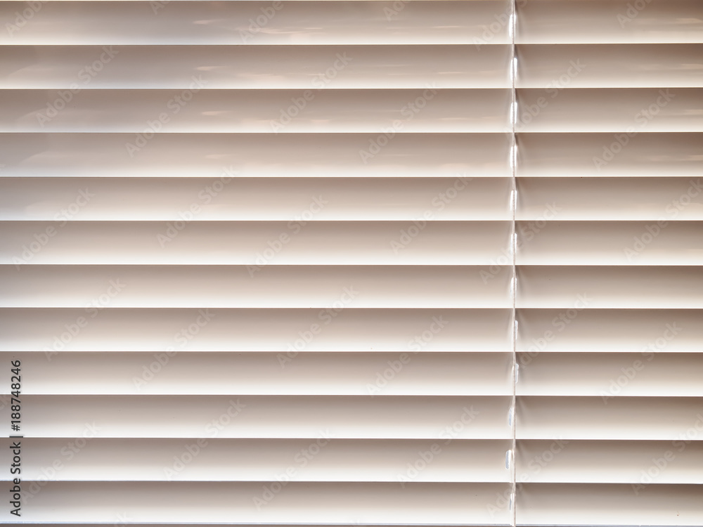Closed window blinds background in sunny day Closed window blinds background in sunny day