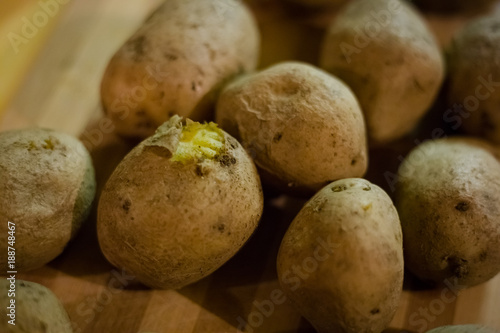 hot boiled potatoes on a wooden board.