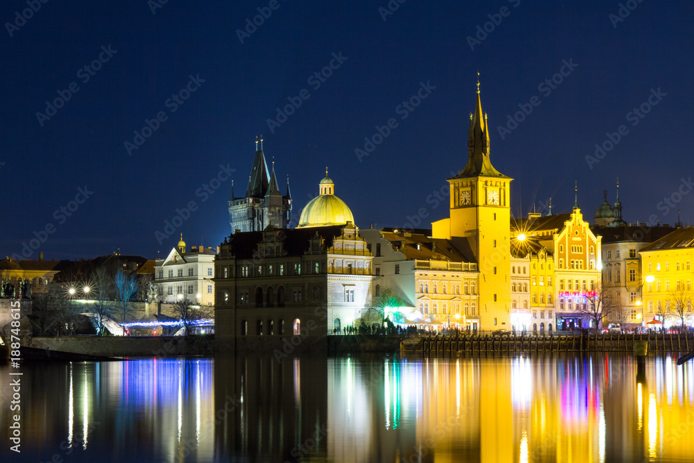Fototapeta premium Beautiful night view of the Charles Bridge, the Old Town Bridge Tower, and the Old Water Tower, the Smetana Embankment and the Prague Beer Museum in Czech Republic New Year's Eve