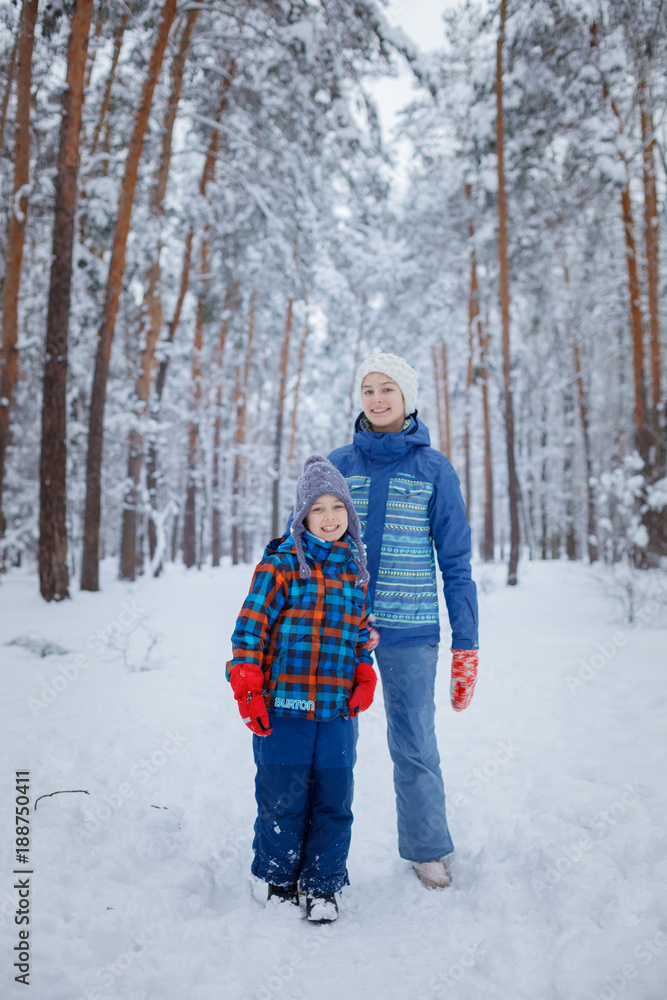 Happy children walking and having fun on snowy winter day.