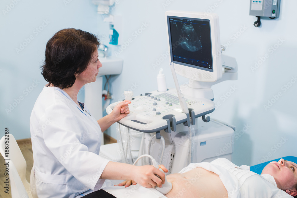 pregnant woman and doctor hands with ultrasound equipment pregnant woman and doctor hands with ultrasound equipment