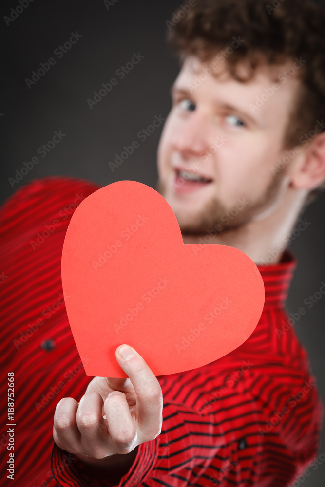 Cheerful man holding heart. Cheerful man holding heart.