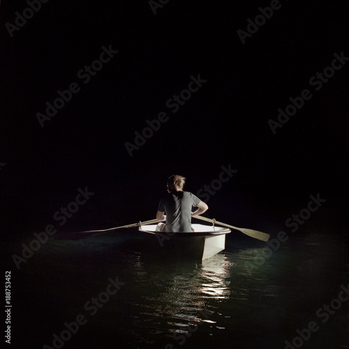 Man in boat lost at sea photo