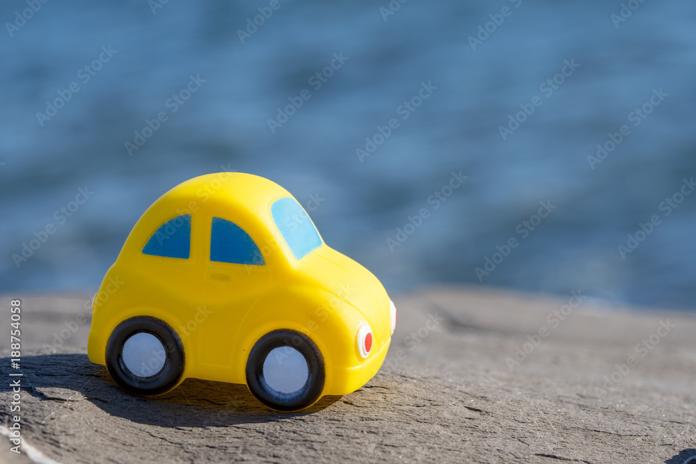 Toy Car near the sea. Travel, tourism, holiday and adventure concept.