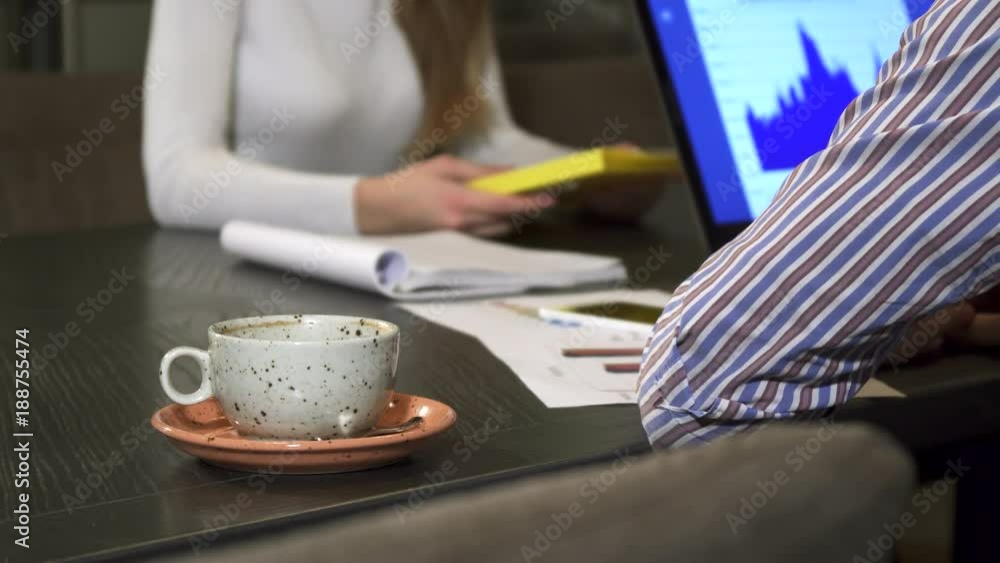 Cup of coffee on the table at the office business people having a meeting Cup of coffee on the table at the office business people having a meeting