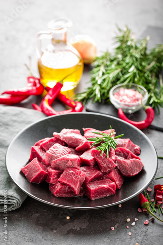 Raw beef meat sliced on black background