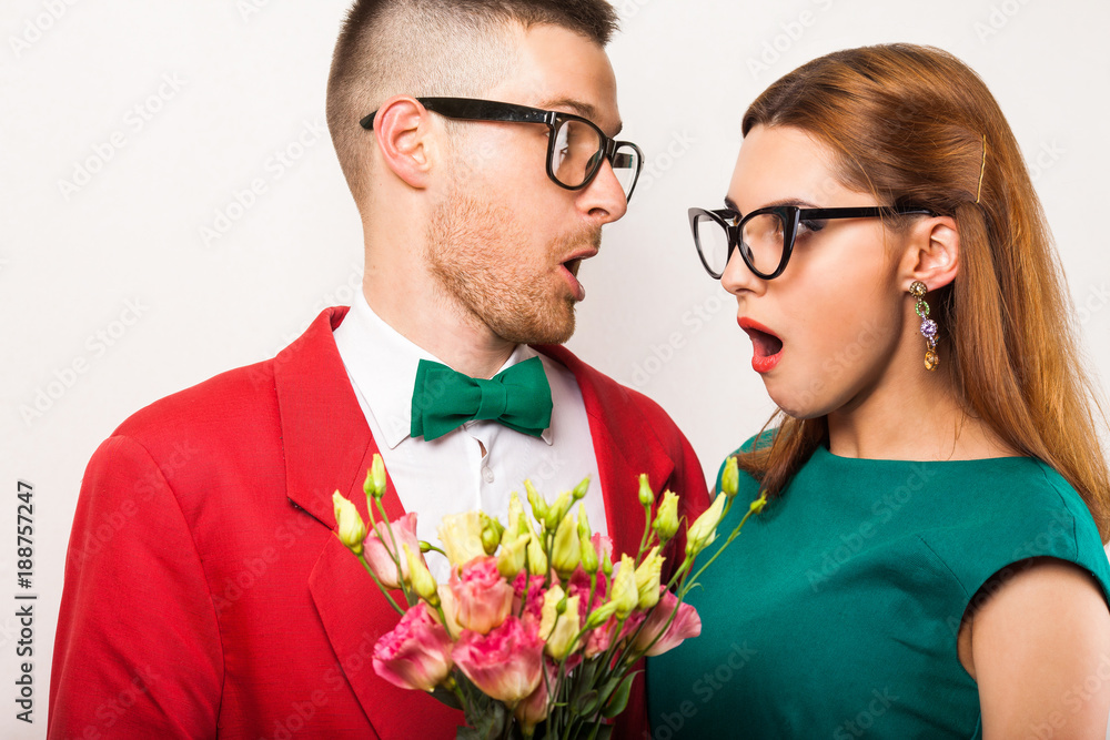 hipster couple in love with a bouquet of flowers in the studio at Christmas, the concept of Valentine's Day hipster couple in love with a bouquet of flowers in the studio at Christmas, the concept of Valentine's Day