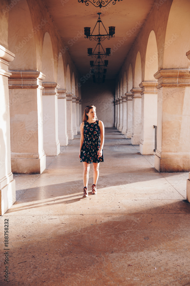 Woman in Dress in Arched Walkway