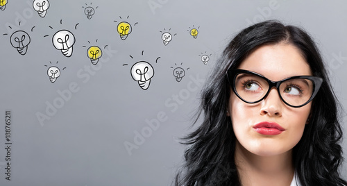 Light Bulbs with young businesswoman in a thoughtful face