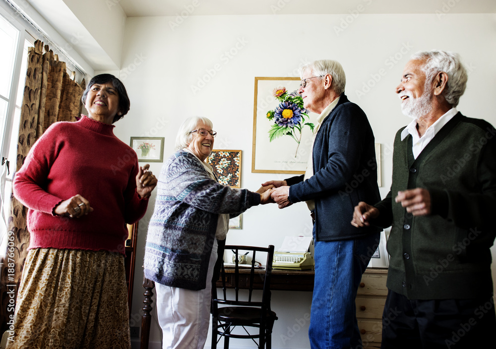 Fototapeta premium Senior friends dancing together at home