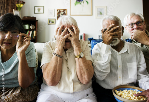 Valokuva Senior friends sitting on the couch with horrified reaction