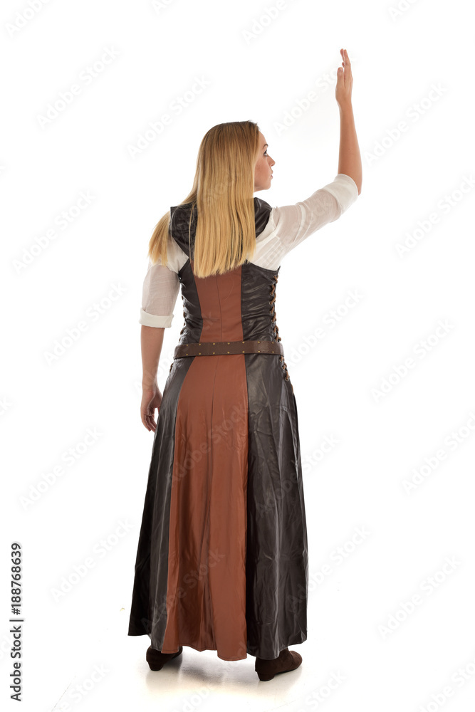 full length portrait of girl wearing brown fantasy costume, standing pose with back to the camera on white studio background. full length portrait of girl wearing brown fantasy costume, standing pose with back to the camera on white studio background.