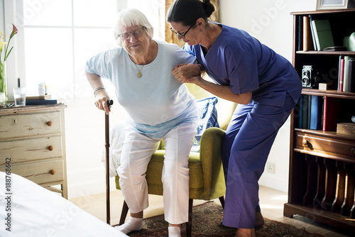 Fotografi Nurse helping senior woman to stand