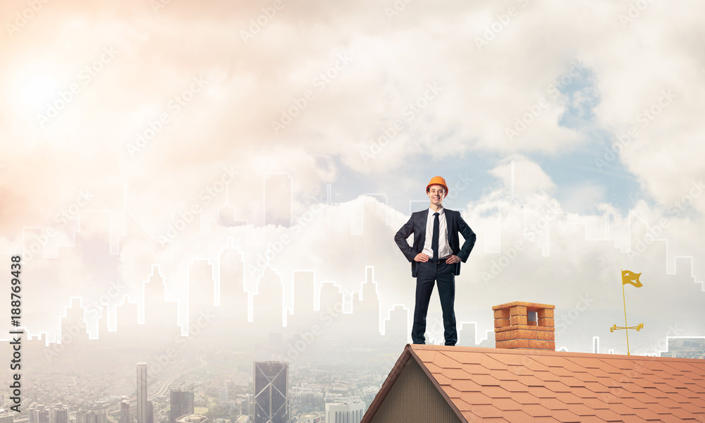 Engineer man standing on roof and looking away. Mixed media Engineer man standing on roof and looking away. Mixed media