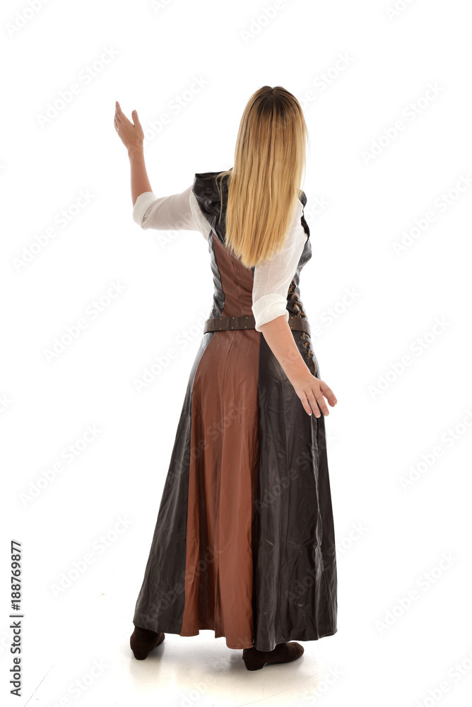 full length portrait of girl wearing brown  fantasy costume, standing pose with back to the camera on white studio background. 