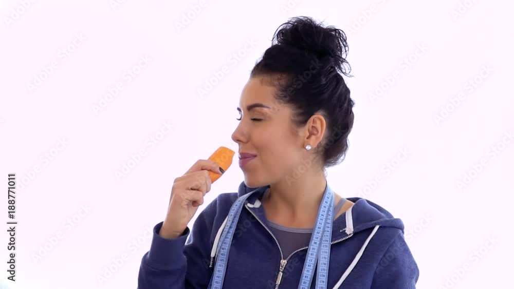 Young woman prefer eating chocolate than carrot Young woman prefer eating chocolate than carrot