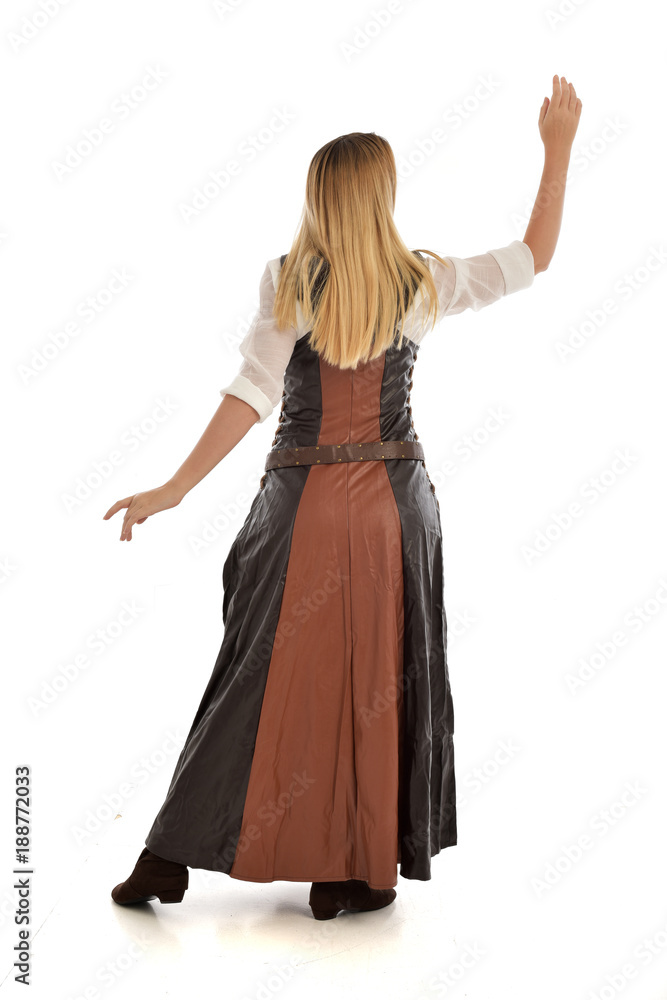 full length portrait of girl wearing brown fantasy costume, standing pose with back to the camera on white studio background. full length portrait of girl wearing brown fantasy costume, standing pose with back to the camera on white studio background.