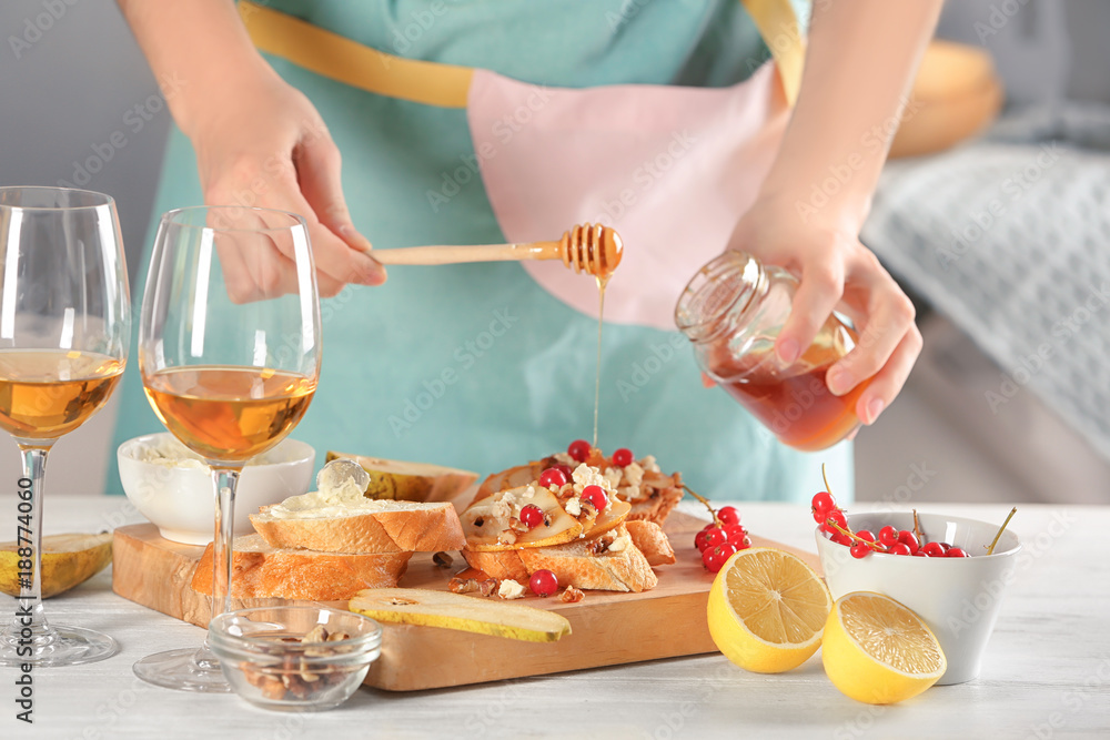 Woman preparing delicious bruschettas on table Woman preparing delicious bruschettas on table